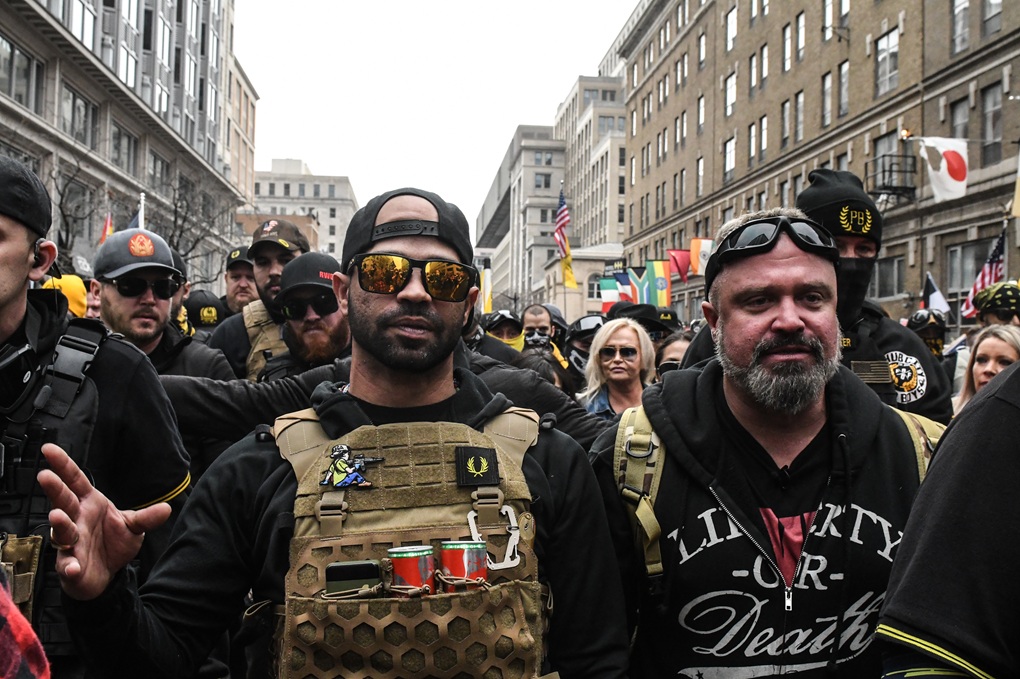 Enrique Tarrio, leader of the Proud Boys (left), and Joe Biggs (right) gather outside Harry's bar during a protest on December 12, 2020, in Washington, DC. (Stephanie Keith/Getty Images)