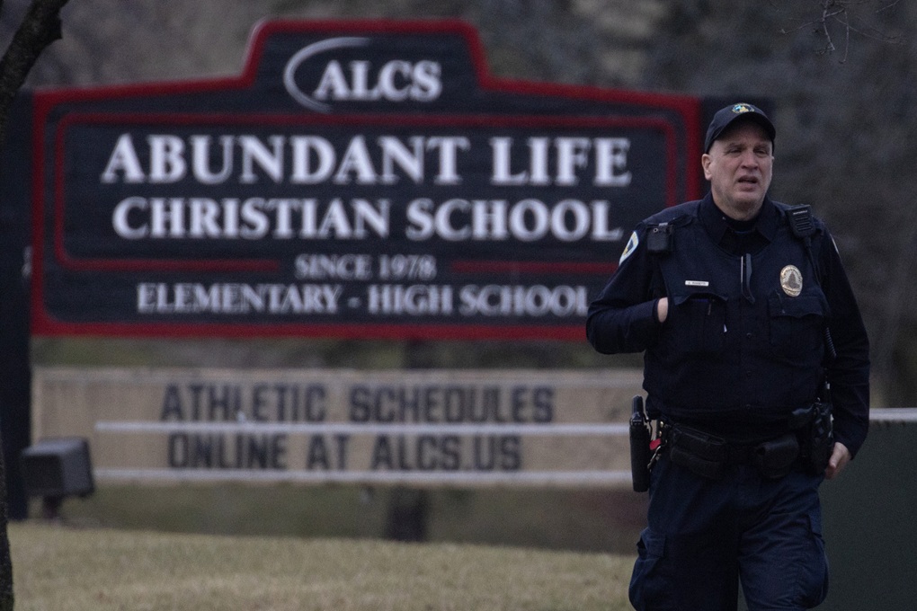 A police officer walks in front of Abundant Life Christian School on December 16, 2024, in Madison, Wisconsin, where a student and teacher were killed in a shooting attack.