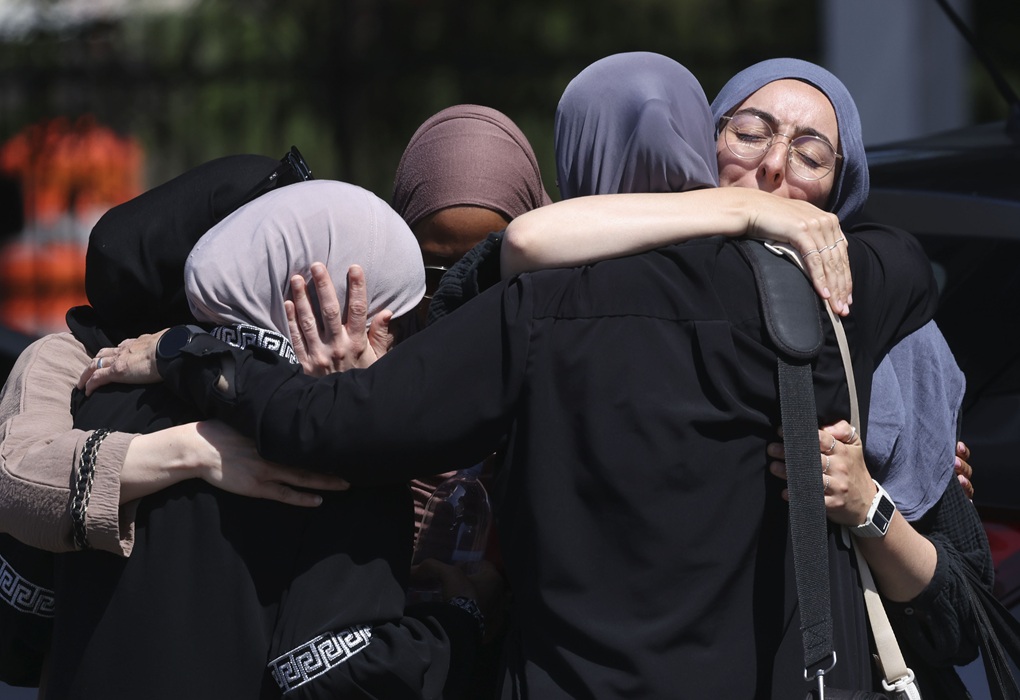 Mosque members embrace in the parking lot of the Islamic Center of San Diego (ICSD) on May 19, 2026