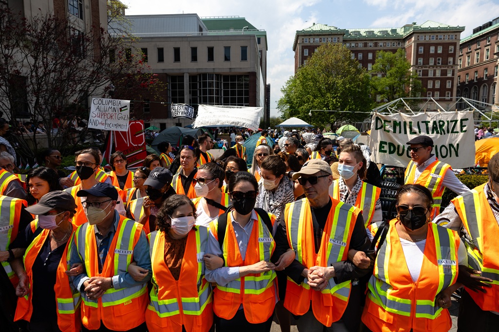 Columbia faculty members protect students in the "Gaza Solidarity Encampment" on the West Lawn of Columbia University on April 29, 2024, in New York City.