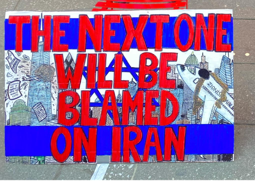 Image: An antisemitic sign displayed by an anti-Israel activist in New York City in 2026 shows planes.