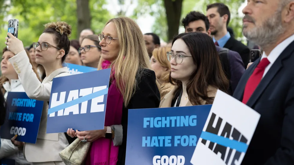 People on the frontline with signs: "No Hate" and "Fighting Hate for Good."