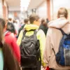 Rearview of students walking in a school hallway