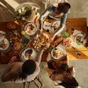 Family eating dinner at the table shot from above