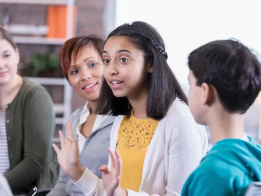Teenage girl talks in group therapy session