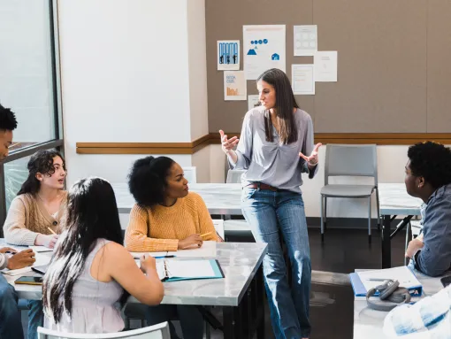 Female teacher leads group discussion in classroom