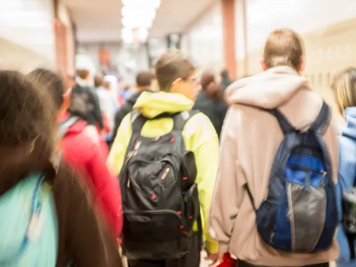 Rearview of students walking in a school hallway