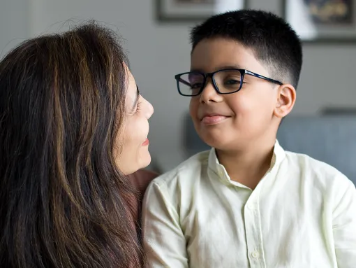 Loving mother embracing son at home