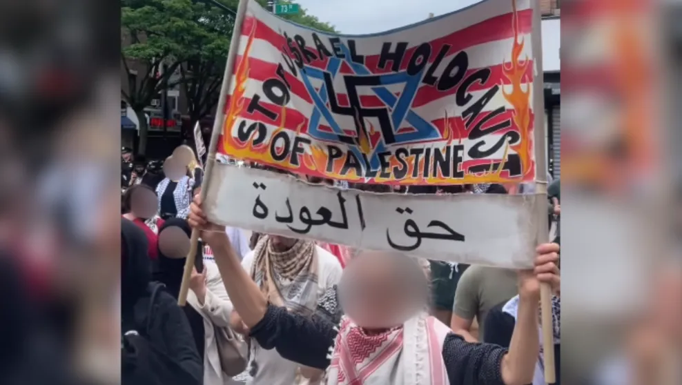 A woman holds an antisemitic sign