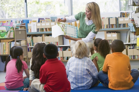Teacher in Class Reading to Students