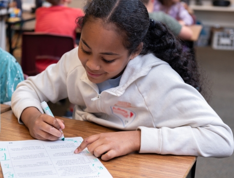 Young girl completing lesson in class