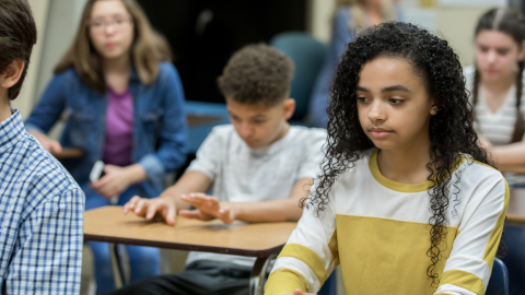 Diverse group of high school students looking bored and depressed