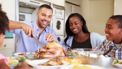 Family Sitting Around Table at Mealtime