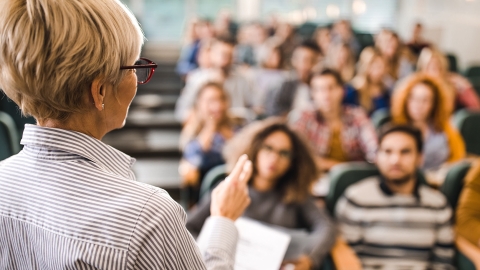 Professor lecturing to college students in class