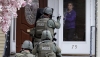 Woman opening door to an armed SWAT team