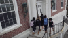 Students walking in and out of a school's front door