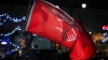 A man holds a Democratic Socialists of America flag at a vigil in Wilkes-Barre, Pennsylvania, November 20, 2022. (Aimee Dilger/SOPA Images/LightRocket via Getty Images)