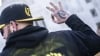 A member of the Proud Boys gestures in front of the Oregon state capitol during a protest on January 8, 2022, in Salem, Oregon, in support of those arrested in the January 6 attack on the U.S. Capitol.