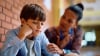 Boy being consoled by teacher